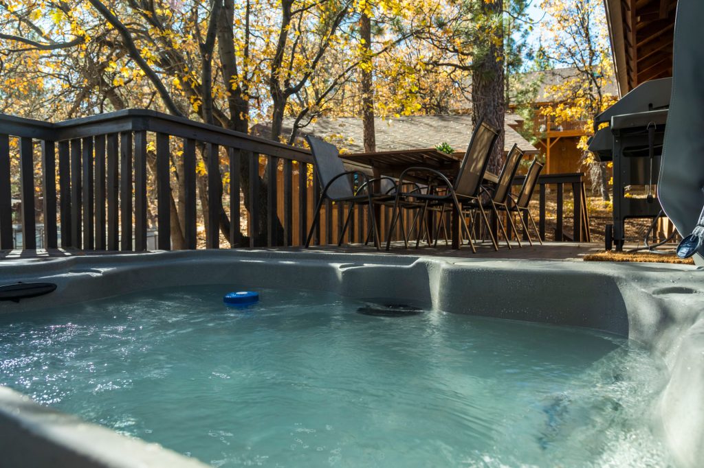 An outdoor hot tub on a deck at a cabin in Big Bear during autumn.