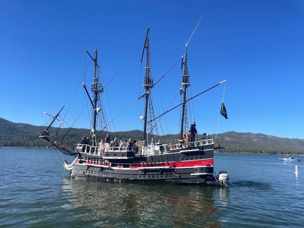 Pirate ship cruise with passengers sailing across Big Bear Lake