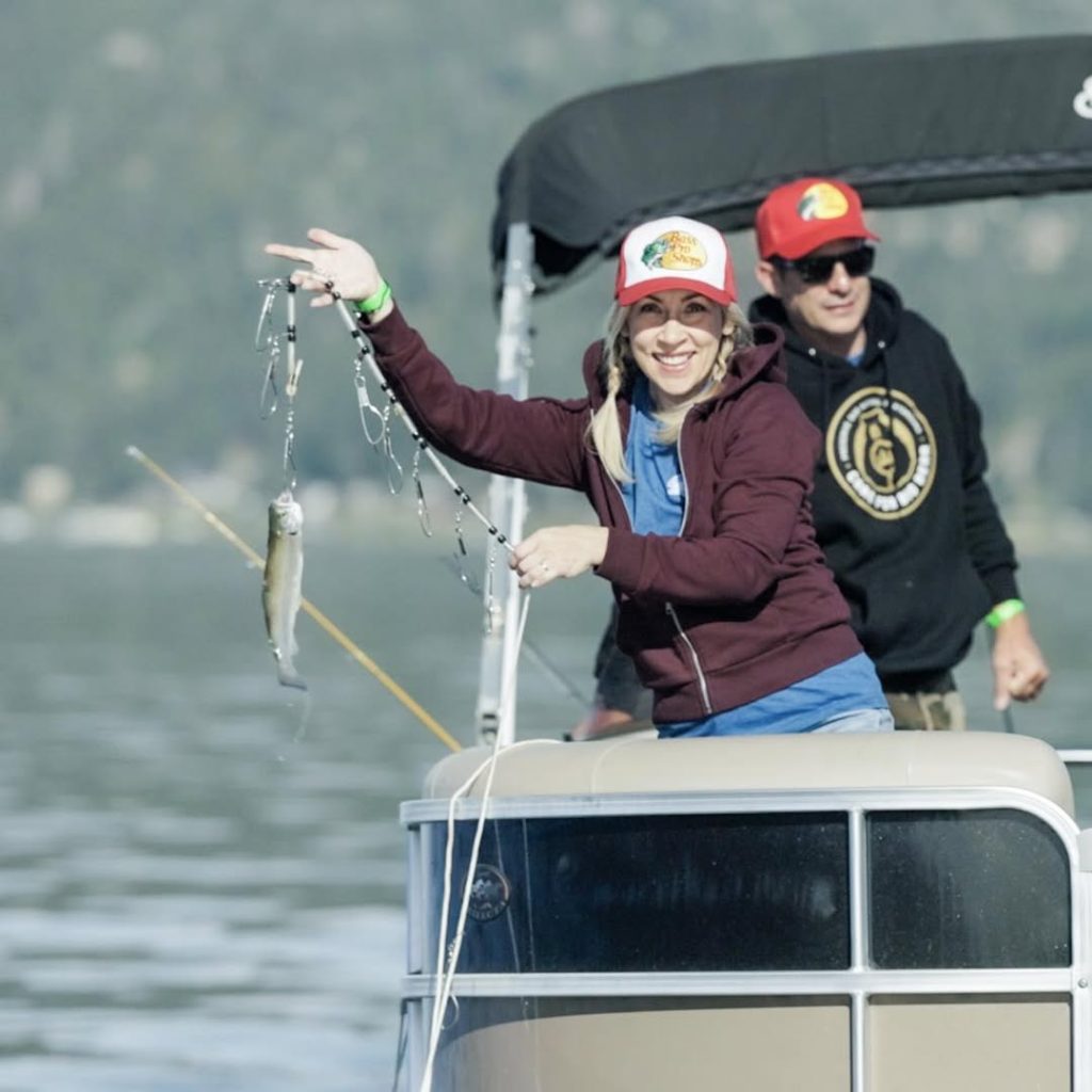 People enjoying a fishing trip on a pontoon boat during a lake adventure.