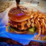 A knife rests on the table beside a cheeseburger and fries at Sandy's restaurant in Big Bear.