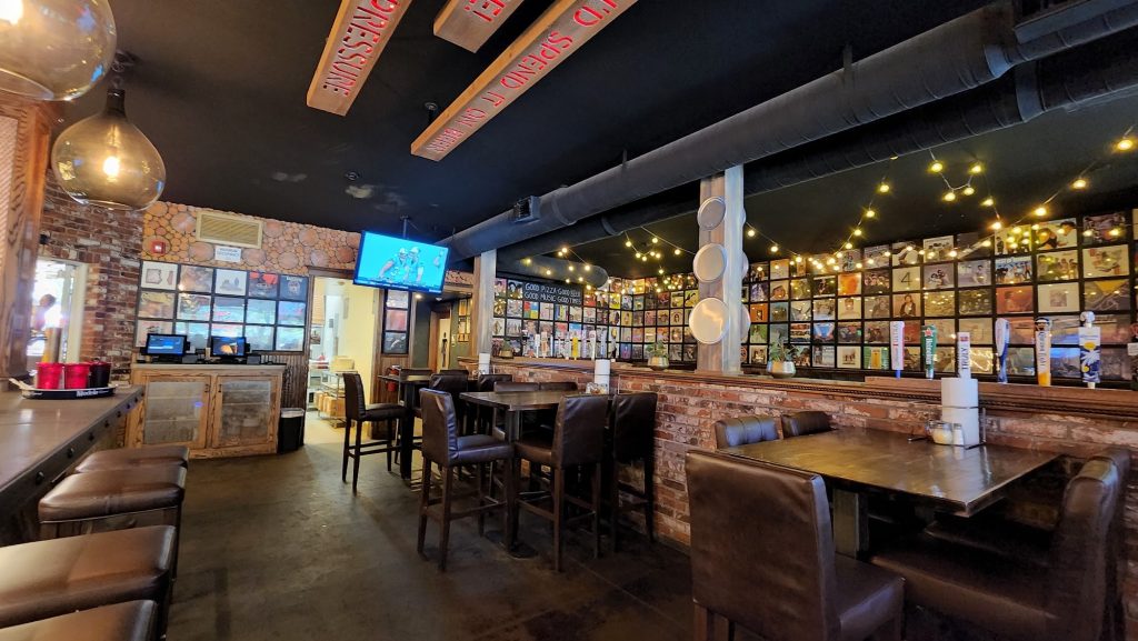 Warm interior seating and bar area inside Saucy Mama’s Pizza and Beer restaurant in Big Bear Lake