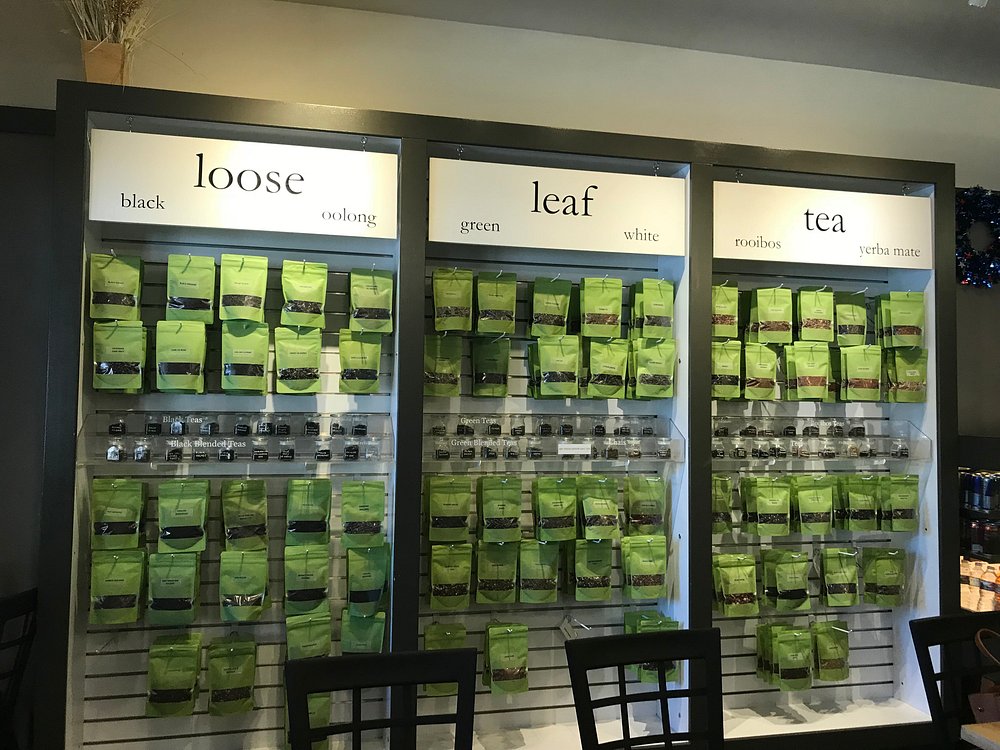 A retail display wall with different types of packaged tea labeled "loose," "leaf," and "tea" at a restaurant in Big Bear.