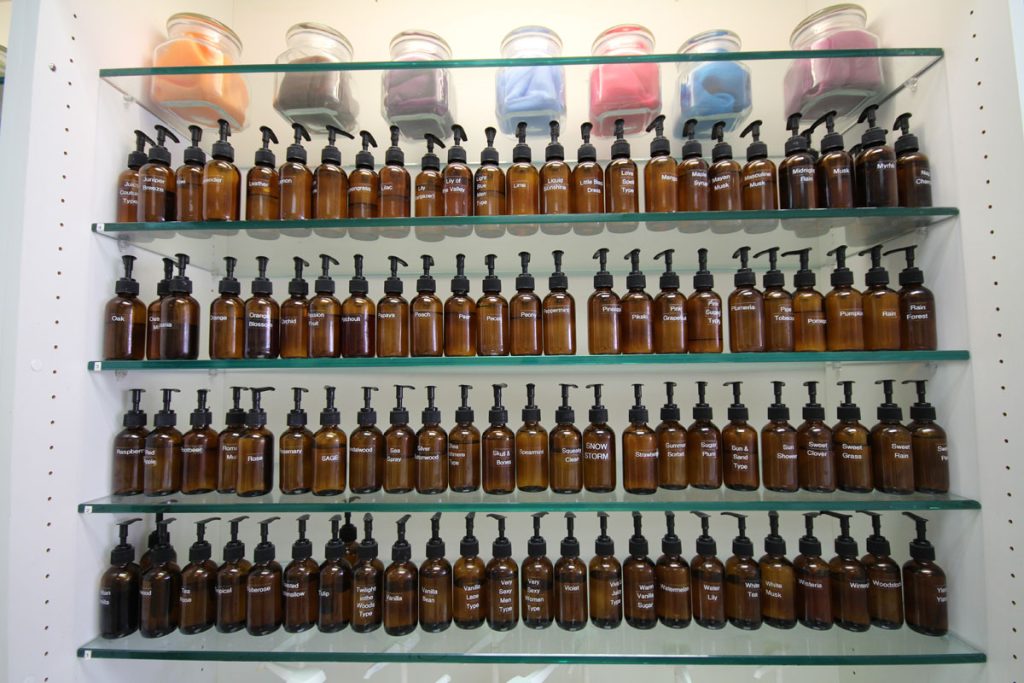 Shelves filled with custom fragrance oils and scents inside The Bath Workshop in Big Bear Lake
