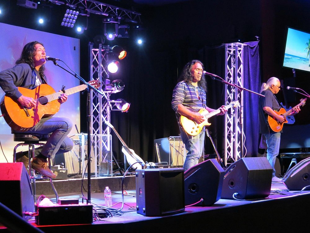 Live band performing on stage with guitars at Village Sports Bar in Big Bear Lake