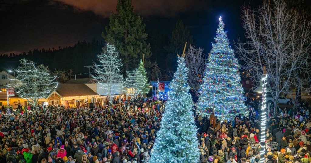 A crowd gathers around a beautifully lit Christmas tree during the Village Christmas Tree Lighting in Big Bear.