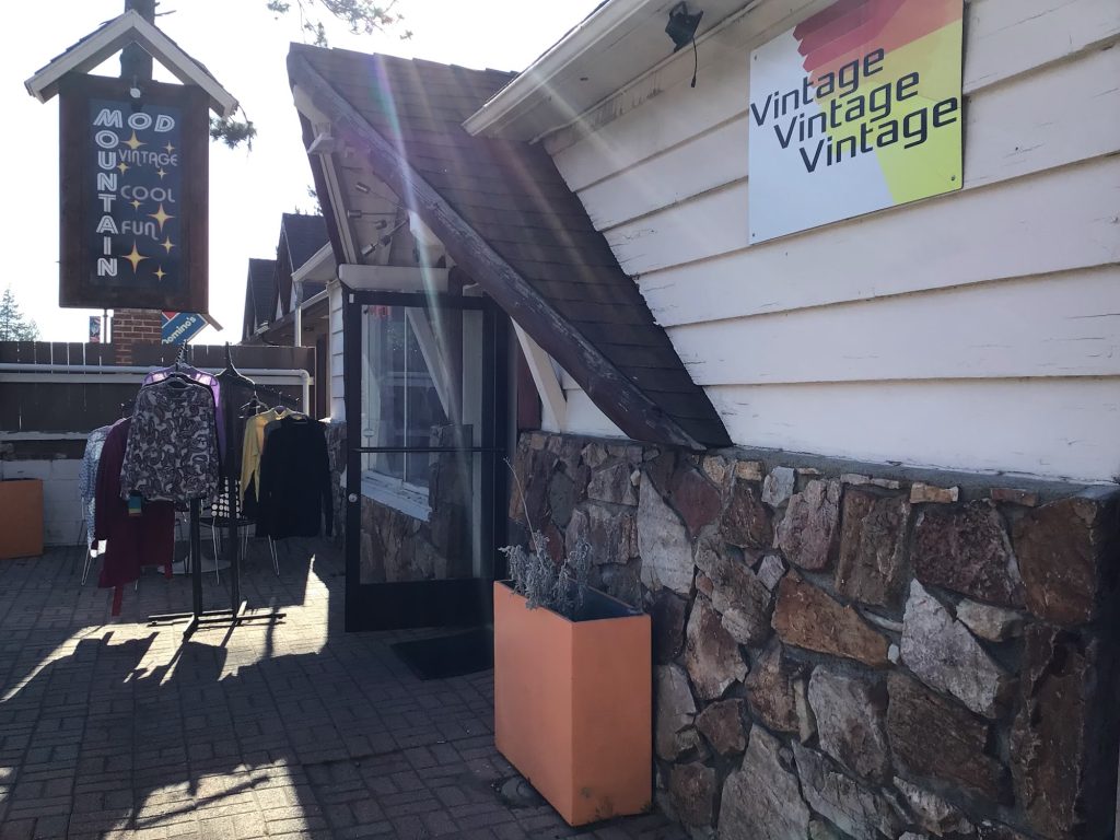 Exterior entrance of Vintage Vintage Vintage clothing boutique in Big Bear featuring retro fashion displays and rustic storefront design